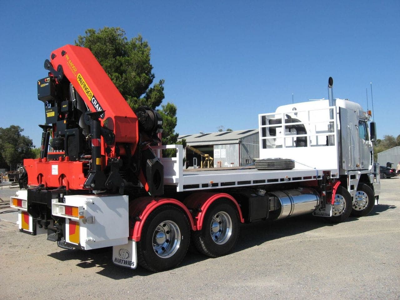 Truck-mounted crane used to transport and lift heavy power equipment
